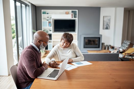 Cropped shot of a senior couple sitting together and going over their financial documents together in their home